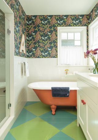 colorful bathroom with chequerboard floor and orange bath by Alison Kandler Interior Design