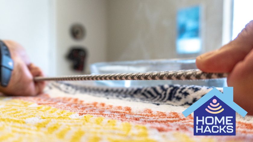 A person straightening out a cable with a Home Hacks badge on the bottom right