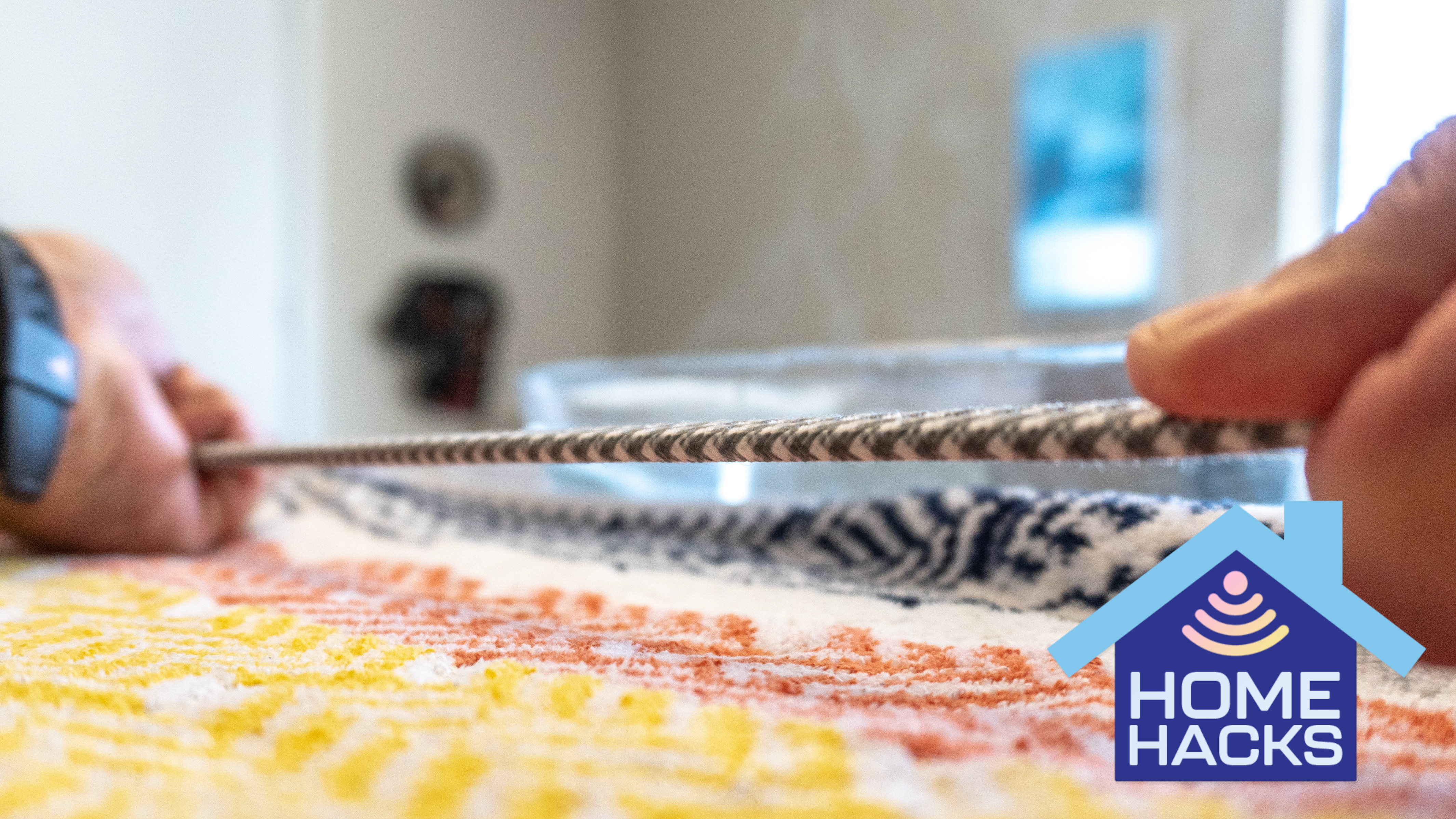 A person straightening out a cable with a Home Hacks badge on the bottom right