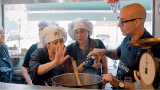 Stanley Tucci pours wine into a dish in Stanley Tucci: Searching for Italy
