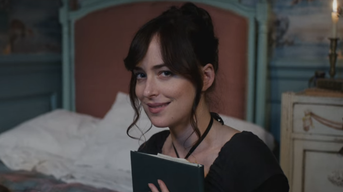 Dakota Johnson as Anne Elliot is reading a book in Persuasion.