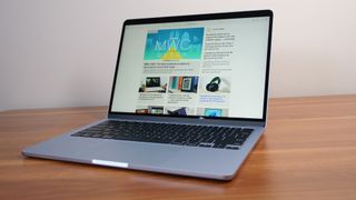 Apple MacBook Air 13-inch M4 angled on a wooden table showing the LaptopMag.com homepage.