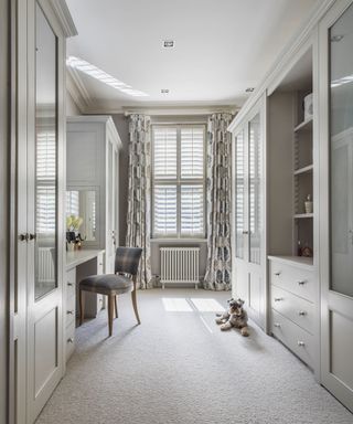 Long narrow dressing room with fitted wardrobes