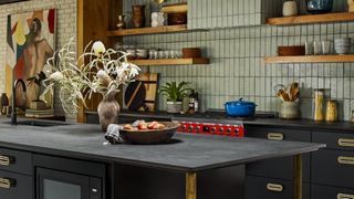 green sage tiles on kitchen walls and black worktop