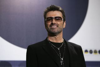 George Michael on the red caret wearing sunglasses 