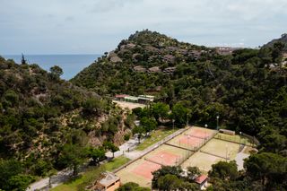 An aerial view of the red clay tennis courts at Zel Costa Brava in Spain