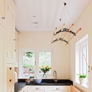 utility room with cream cabinetry and black worktops