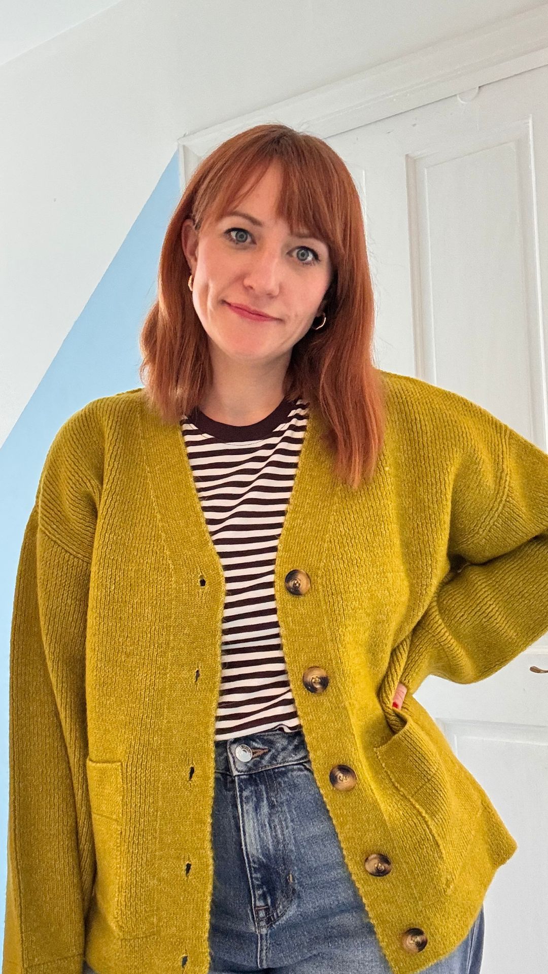 matilda wearing the green asos cardigan over a striped tshirt
