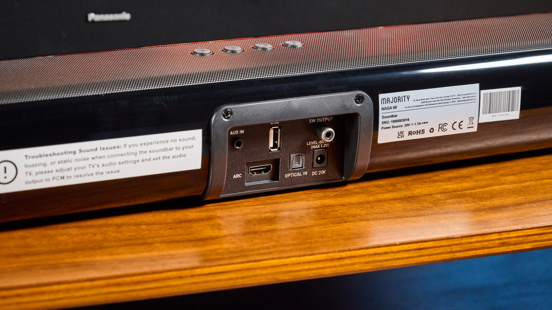 the budget majority naga 60 soundbar in black, showing its buttons and remote