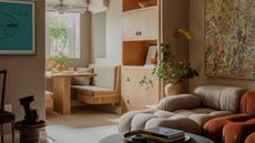 Open plan living room with dark beige walls and wooden dining nook