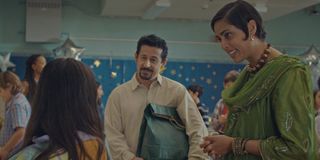 Cash Herrera and Fazeelat Aslam as husband and wife smiling at their daughter at their Eid celebration in American Eid