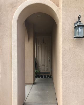 Beige door with concrete path