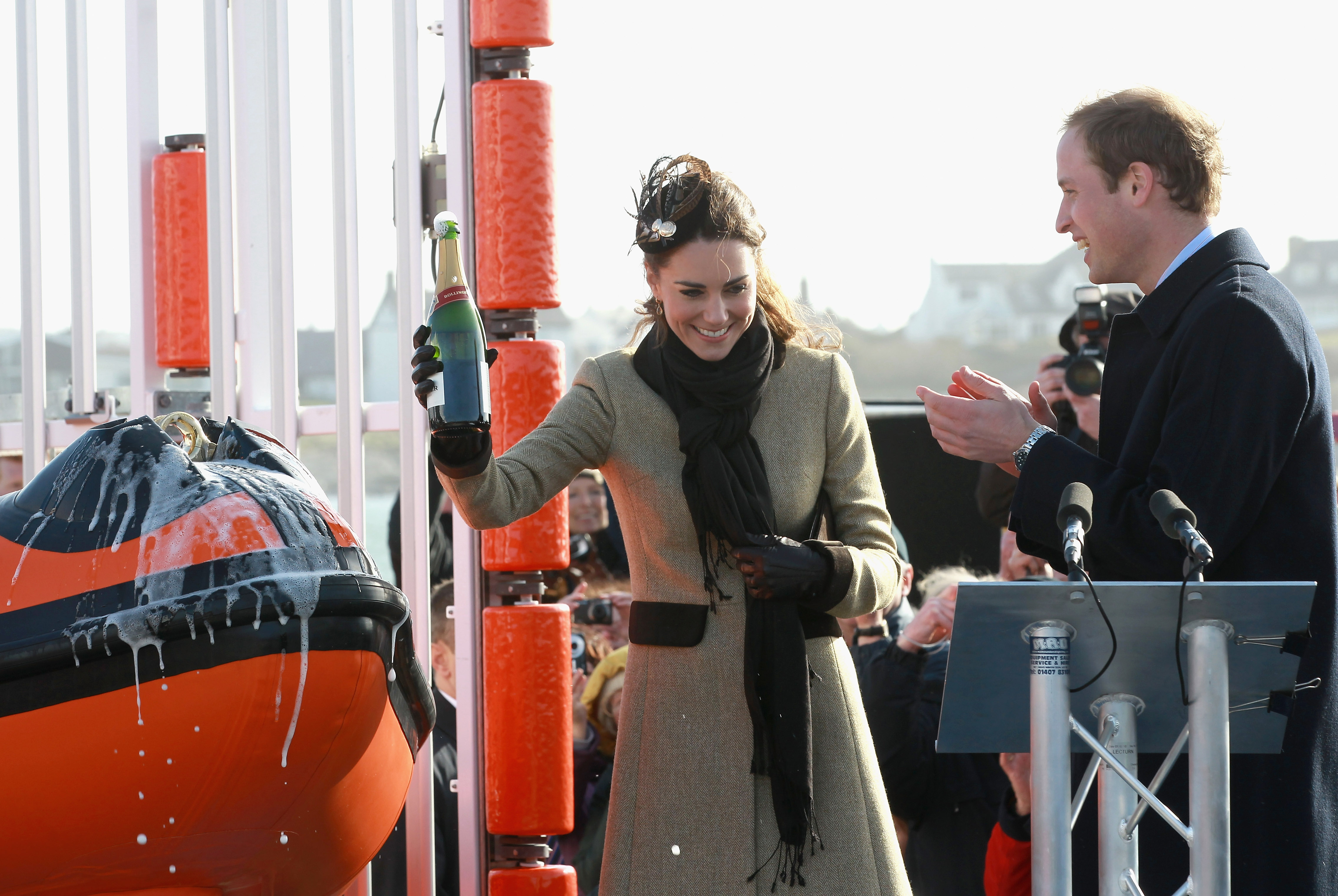 Kate Middleton pouring champagne over a lifeboat