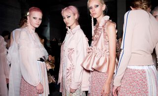 An elegant light pink dress worn by the models.