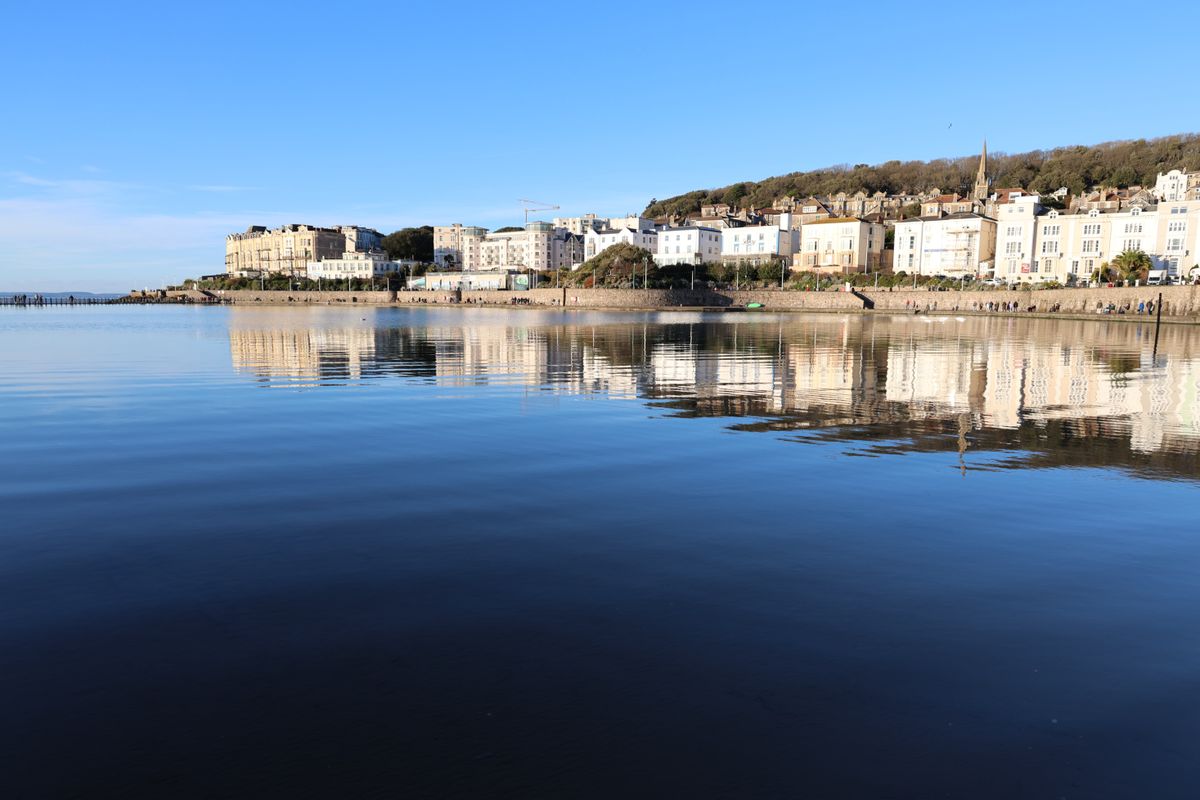 Canon EOS R6 II gallery seaside town reflected in the ocean on calm sunny day