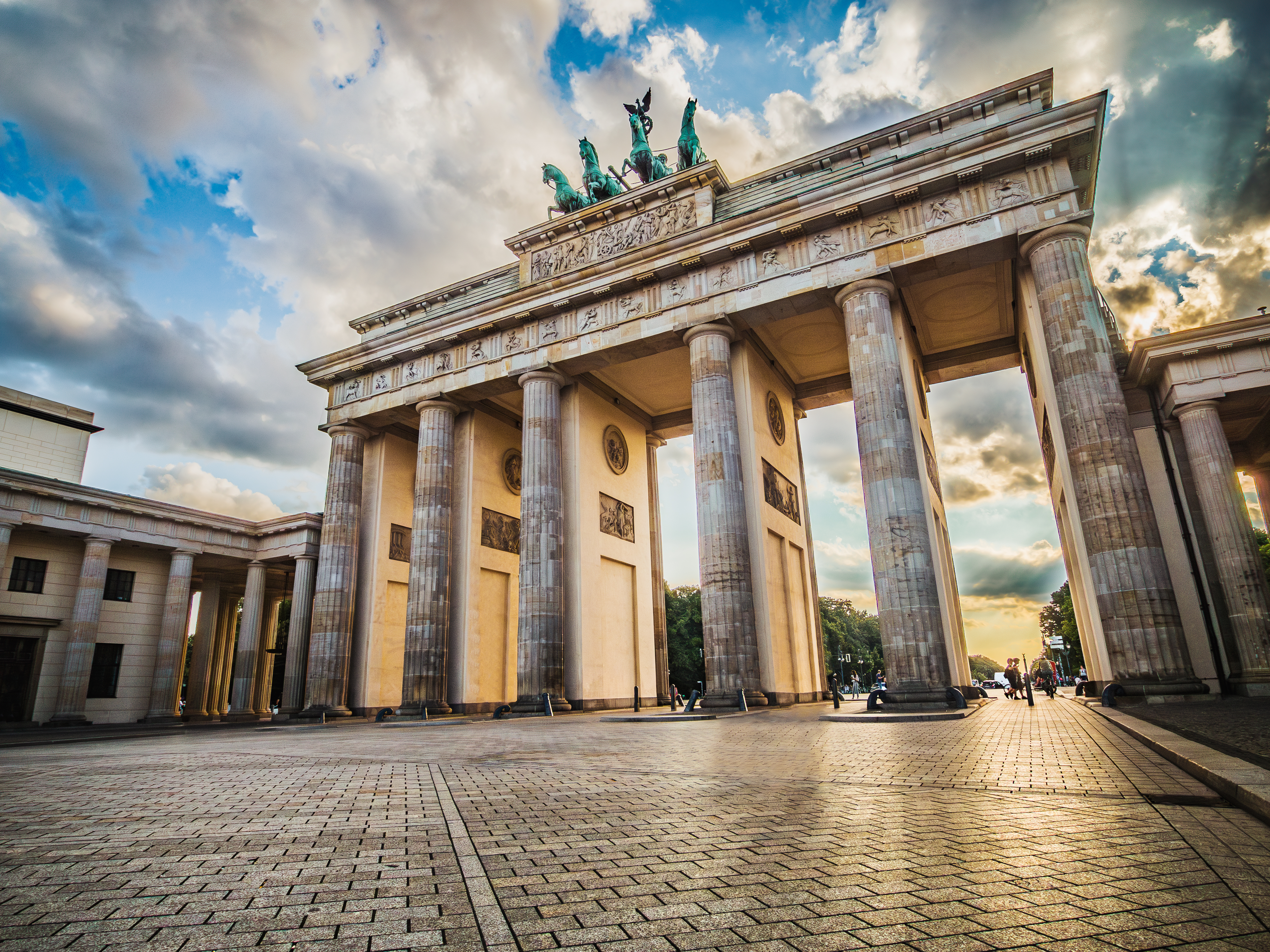 Brandenburg Gate with sunshine and clouds in the background