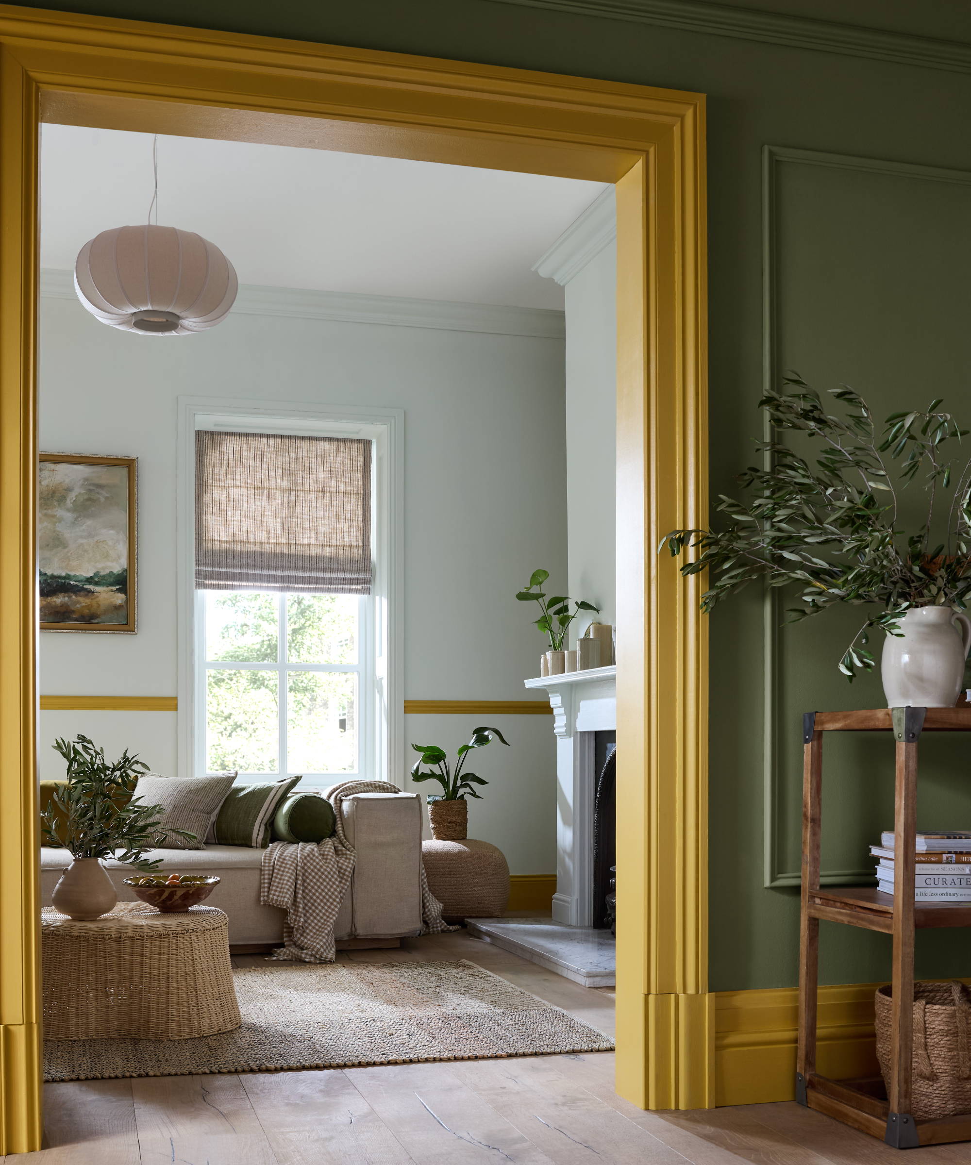 view into living room with pale aqua walls and yellow dado rail