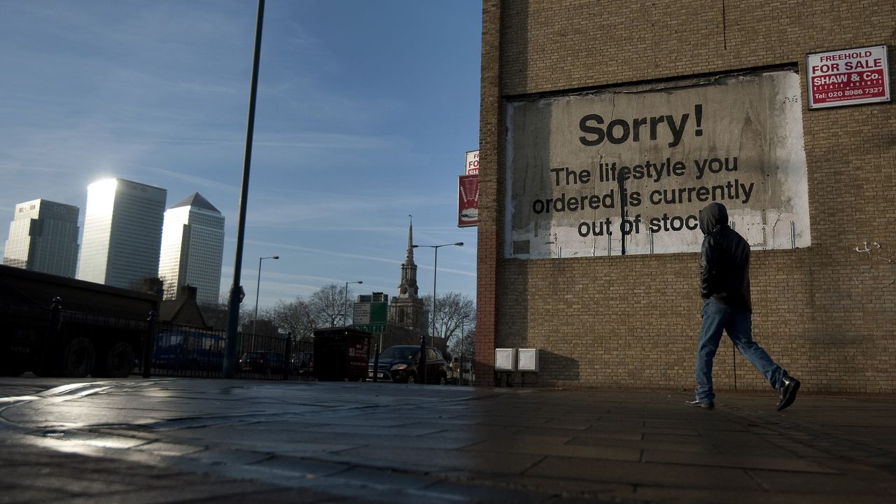 A man walks past graffiti artist Banksy&#039;s 2011 mural &quot;Sorry The Lifestyle You Ordered Is Currently Out Of Stock&quot; in London&#039;s East End