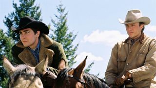 Jake Gyllenhaal and Heath Ledger ride horses in Brokeback Mountain