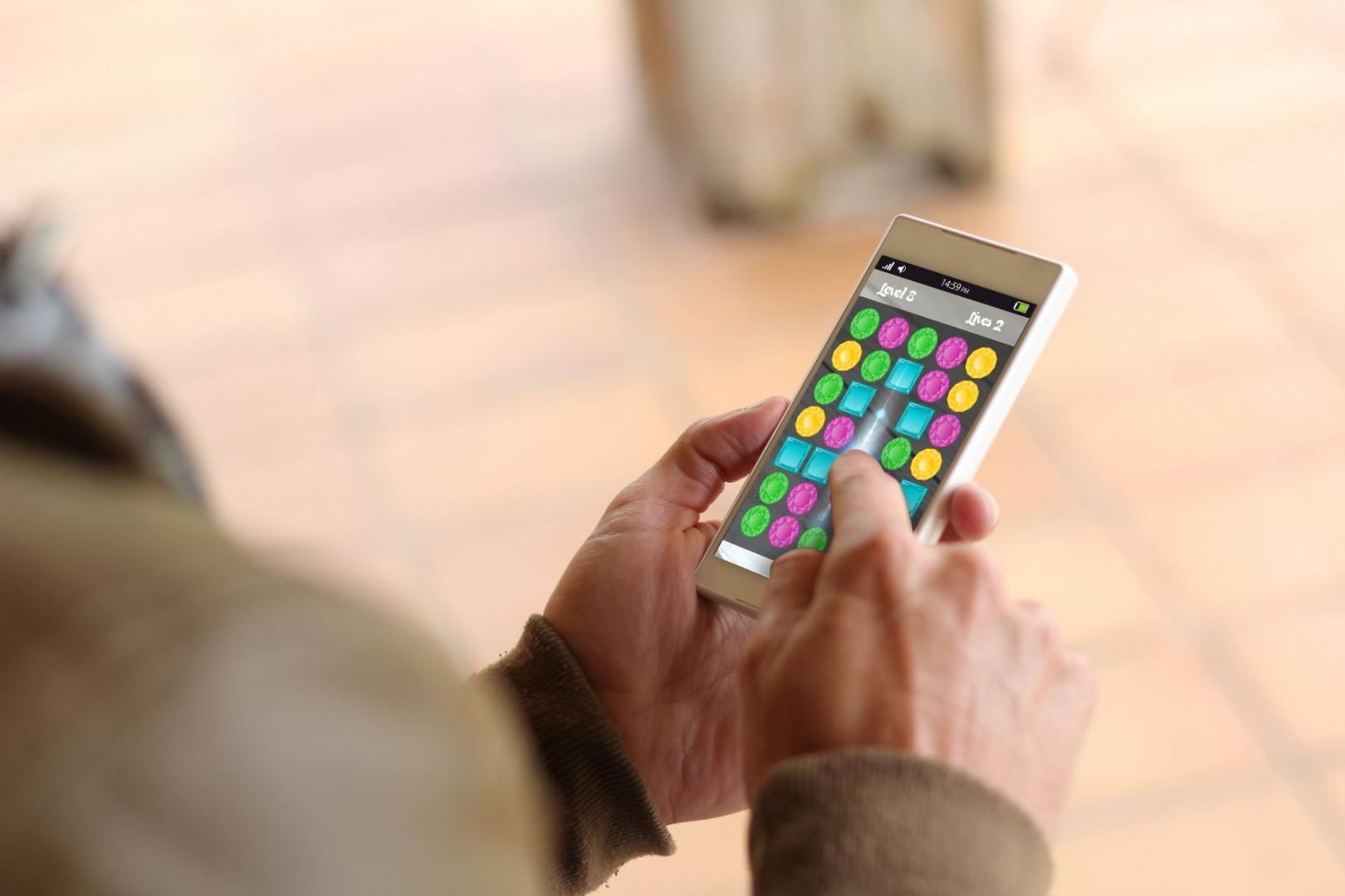 Eine Person spielt ein Handyspiel auf dem Smartphone