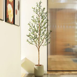 A potted faux tree in a corner