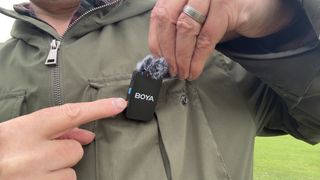 Boyamic microphone attached to a green jacket