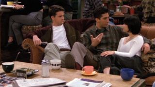 Chandler and Ross on Friends with Reserved sign.