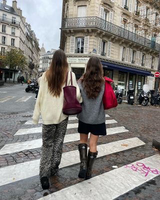 Fashion influencer  @lunaisabellaa wearing an on-trend winter outfit with her friend in Paris.