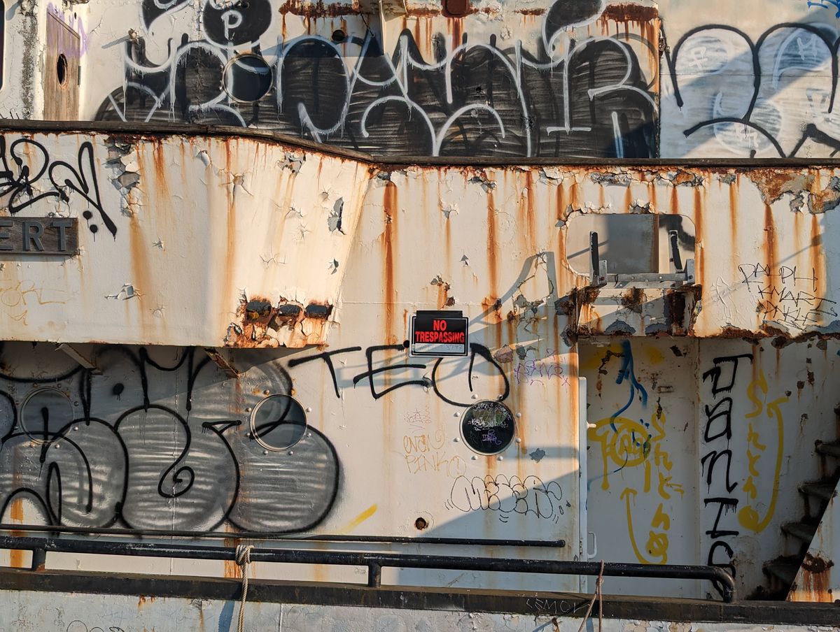 Pixel 7 2x zoom of graffiti on the side of a boat