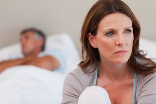 A man and woman in their bedroom