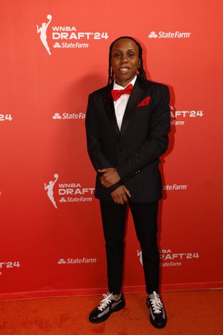 Dyaisha Fair wearing a black tuxedo with red accents to the 2024 WNBA Draft.