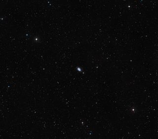 NGC 1512 and NGC 1510 (at center) as seen from the ground, in the surrounding sky.