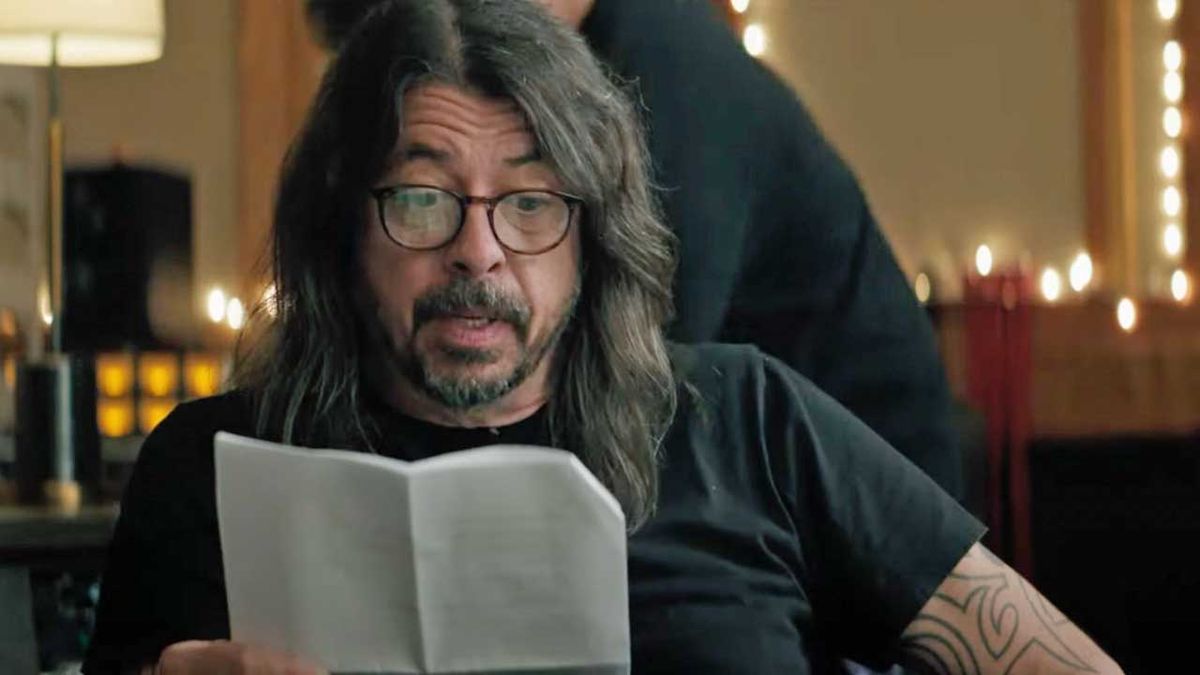 Dave Grohl reading a script in a recording studio 