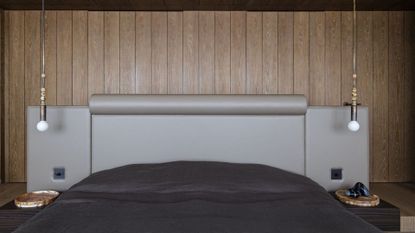 A spacious bedroom with a large headboard