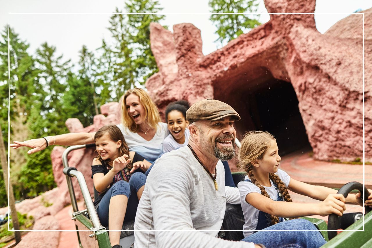 Smiling family on a ride at a theme park