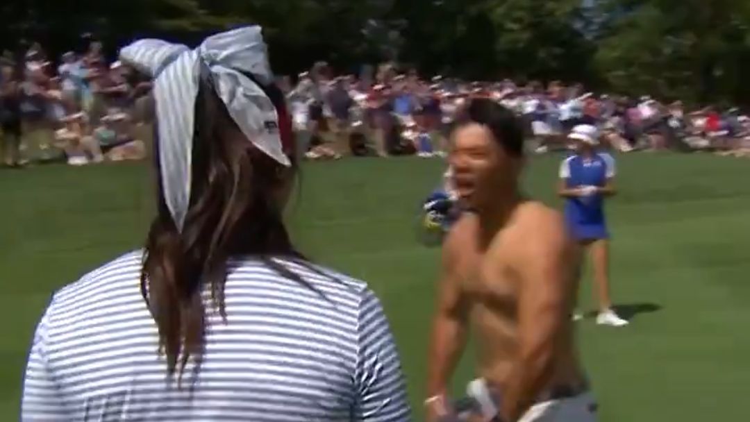 Alison Lee&#039;s caddie take his shirt off to celebrate her hole out at the Solheim Cup