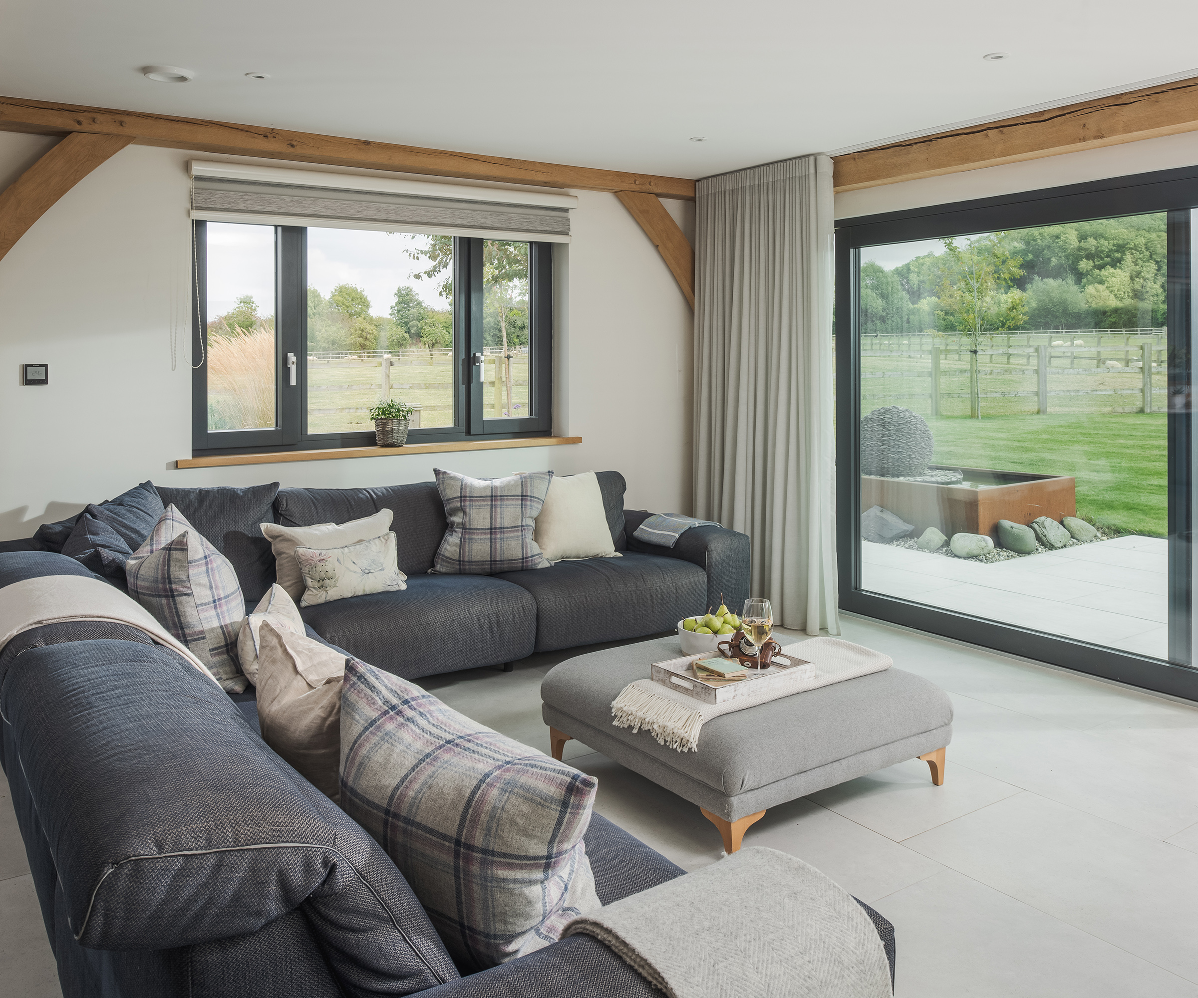 Corner sofa in a living room with glass sliding doors
