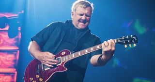 Alex Lifeson his a chord and feels it on his cherry quilted maple top Les Paul Standard.