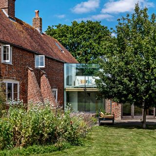 rustic framhouse with glass corridor extension