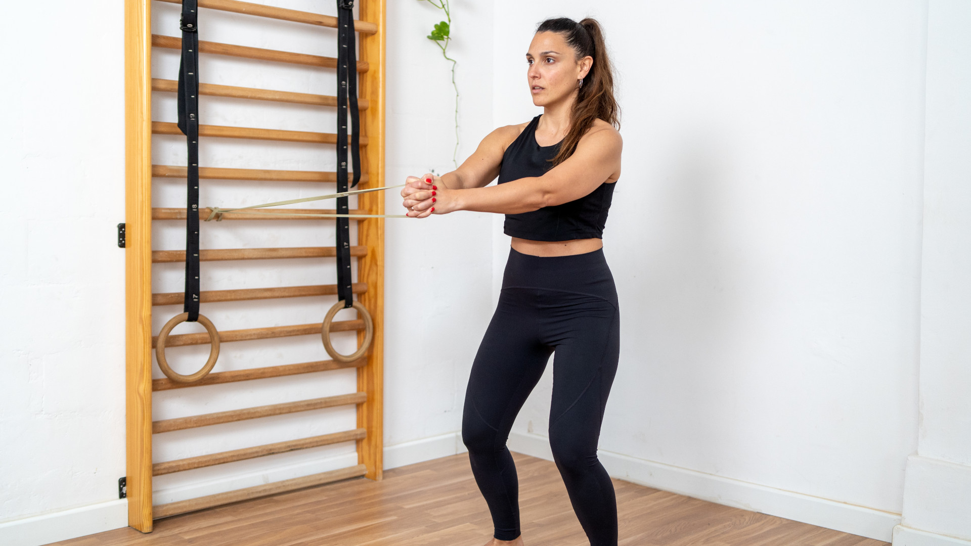 A woman performing pallof press exercise
