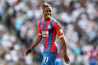 Wilfried Zaha in action for Crystal Palace against Tottenham in 2019.