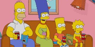 The Simpsons Homer, Marge, Bart, and Lisa sit on the couch, with drinks and snacks at the ready