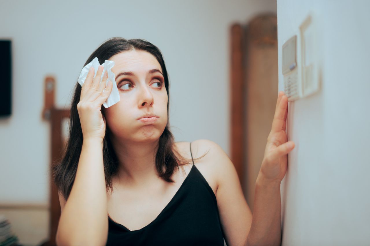 Woman Felling Hot During Summer Setting Her Thermostat