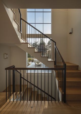 modern staircase with metal balustrade and wooden stairs by Lisa Staton