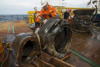 Bezos Expeditions team members clean a gas generator component of an F-1 rocket engine recovered from the Atlantic Ocean floor. The rocket engine was one of five used to launch a mighty Saturn V rocket on one of NASA's Apollo moon missions in the 1960s an