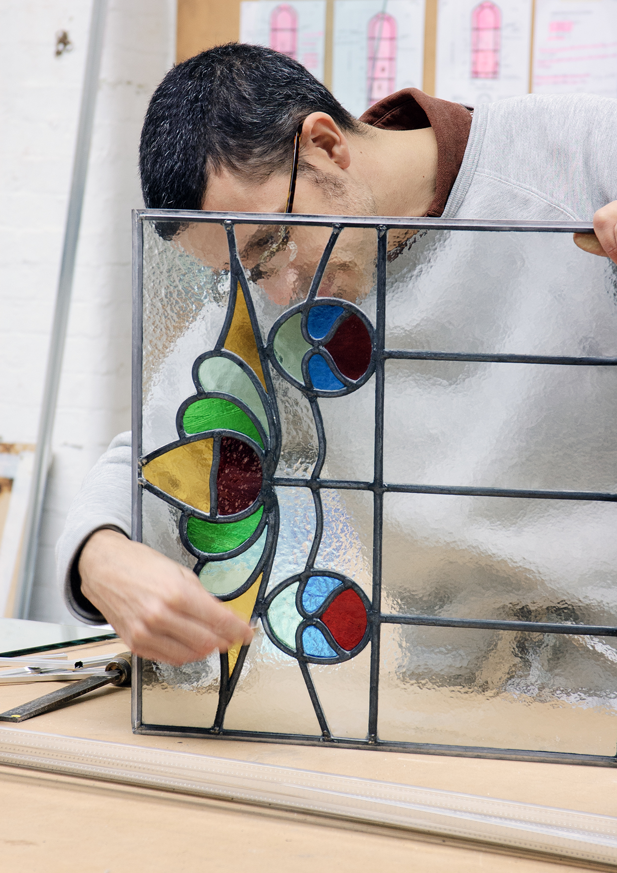 Brian Paverley finishing a stained glass panel.