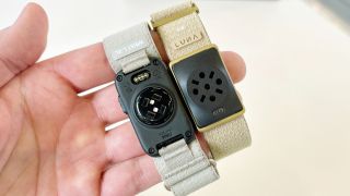 Close-up of the Garmin Cirqa screen-free tracker next to the Luna Band at IFA 2026 in Berlin