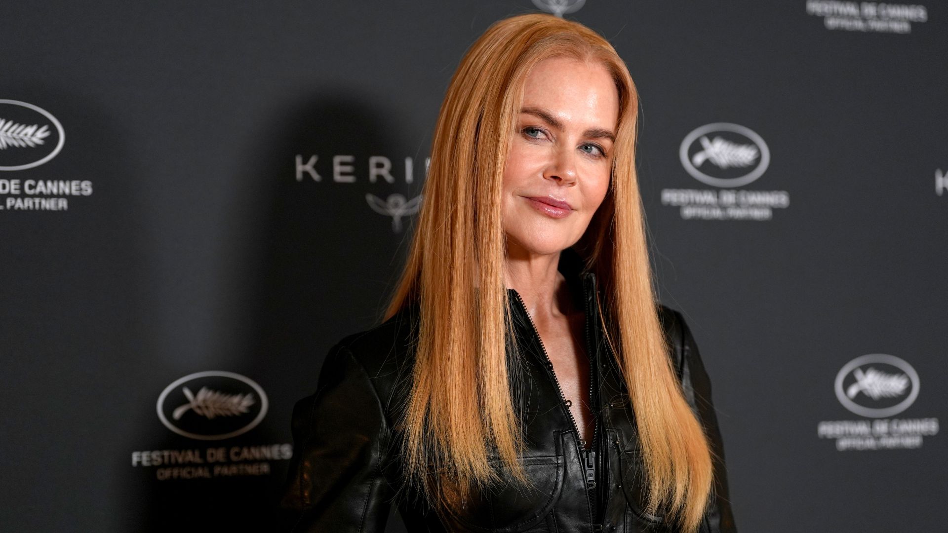 Nicole Kidman standing at film premiere red carpet looking sideways at the camera, representing the Nicole Kidman workout