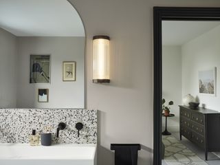 a modern wall light design above a bathroom vanity
