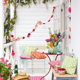 garden area with wall hung decoration and cushions